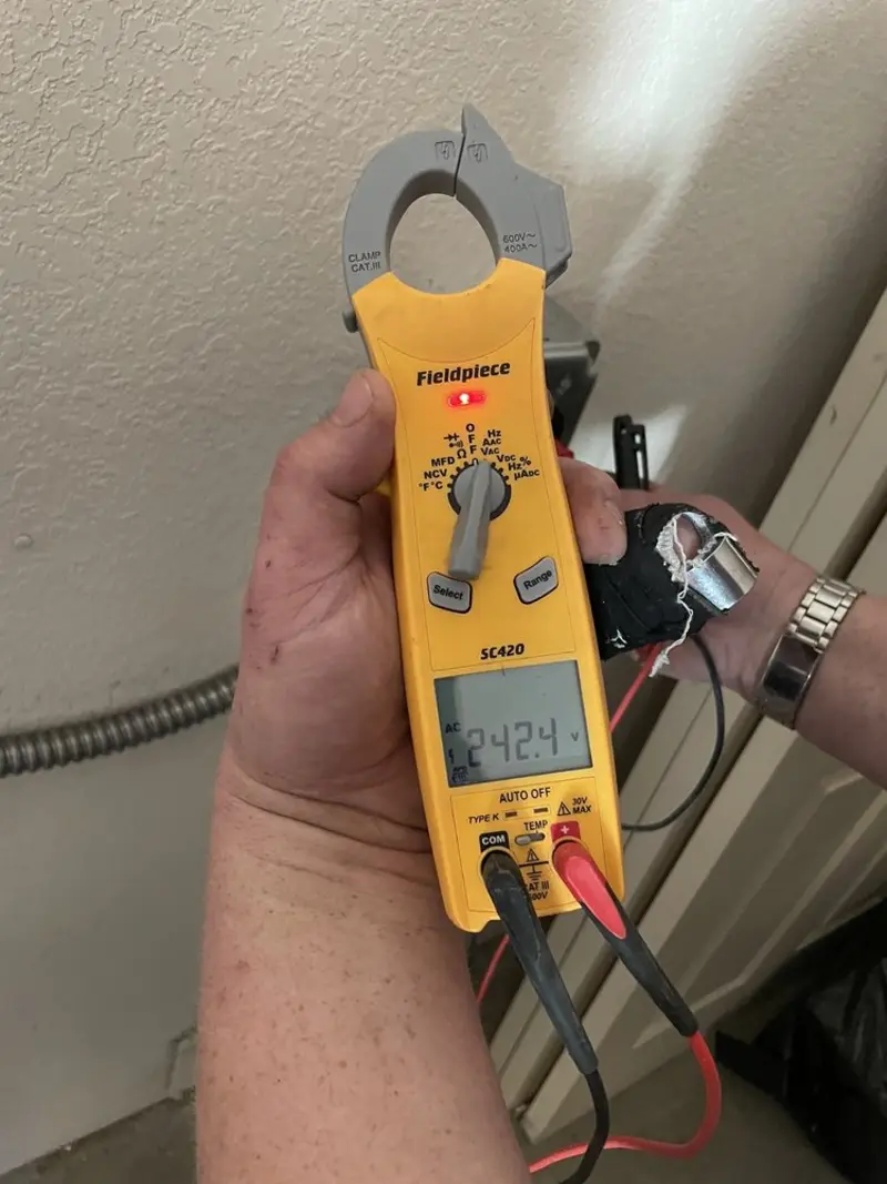 Voltage testing with clamp meter during Electrical Installation Services in Fulton